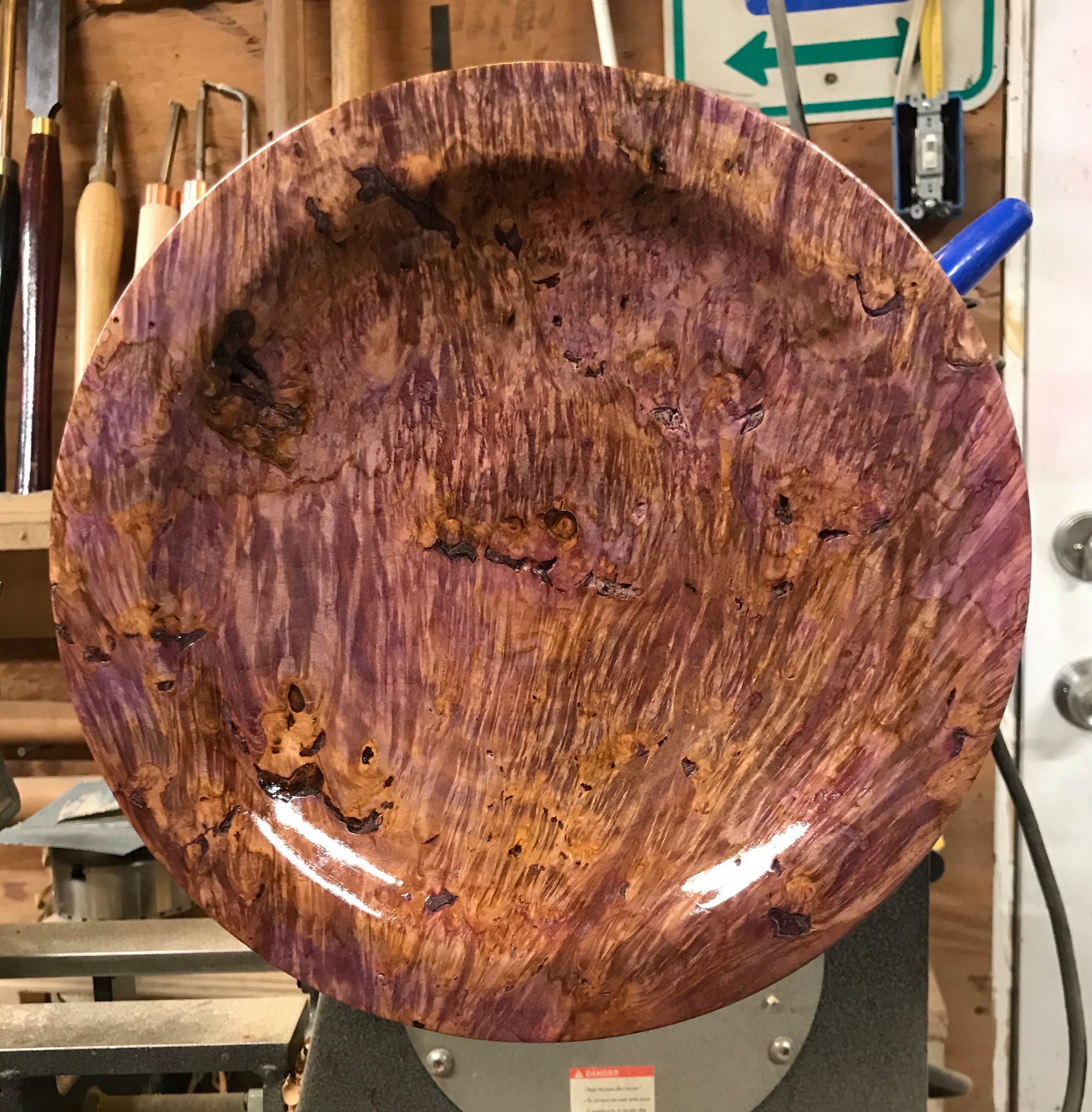 Turned bowl in spalted purple-figured wood with high-gloss finish.