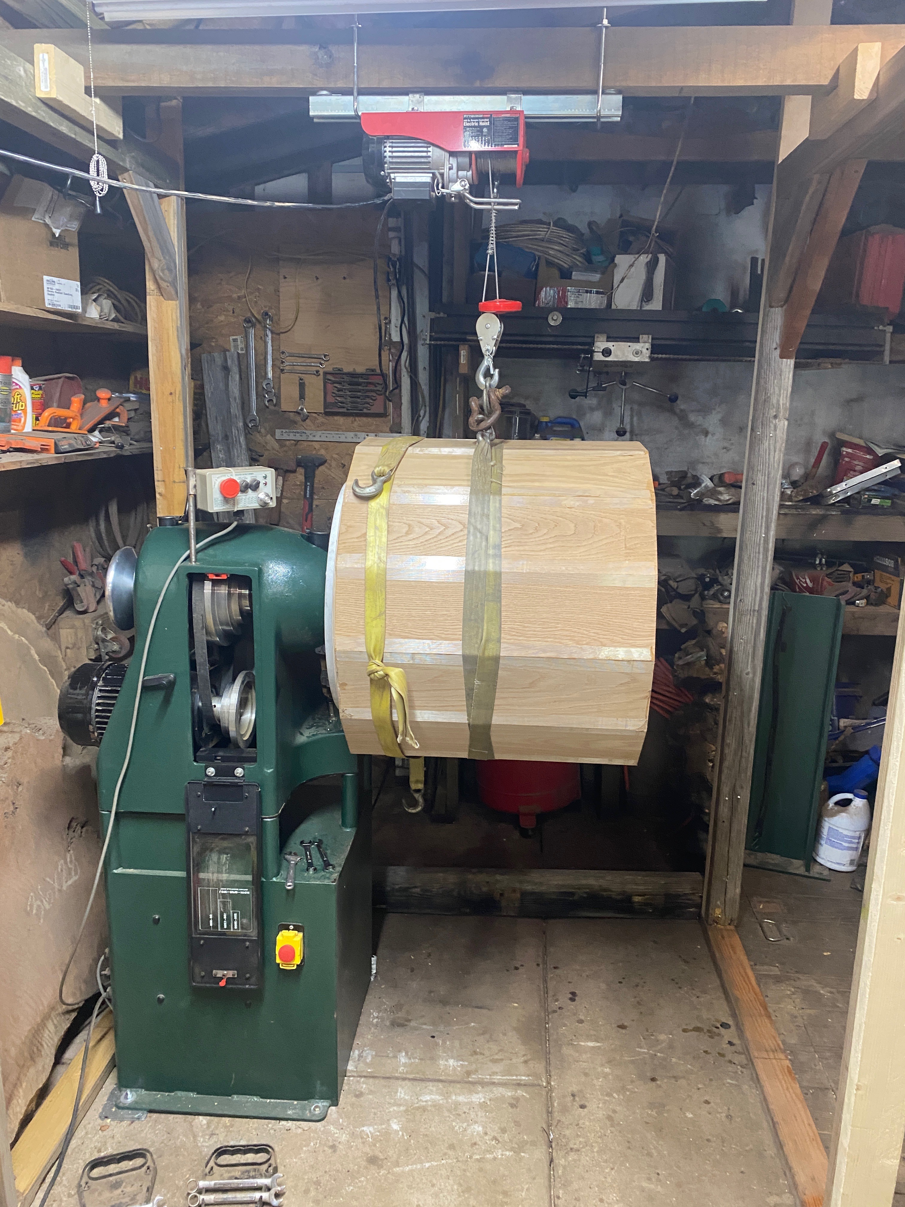 Blank hanging from hoist, closer view approaching the lathe.